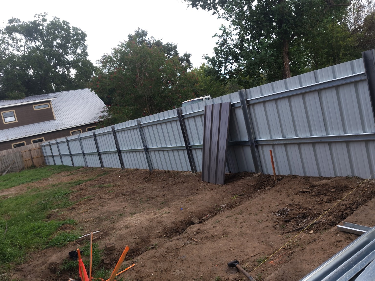 Backside view of a steel fence project under construction
