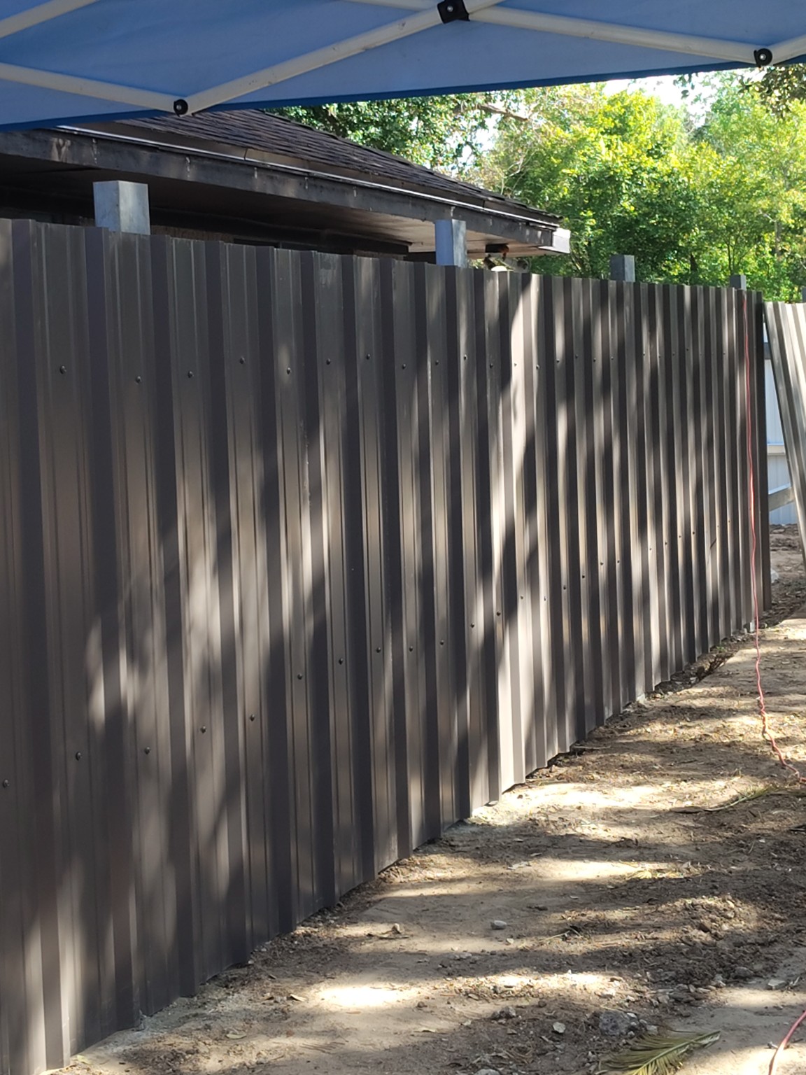 Front view of custom steel fence installed by ACES
