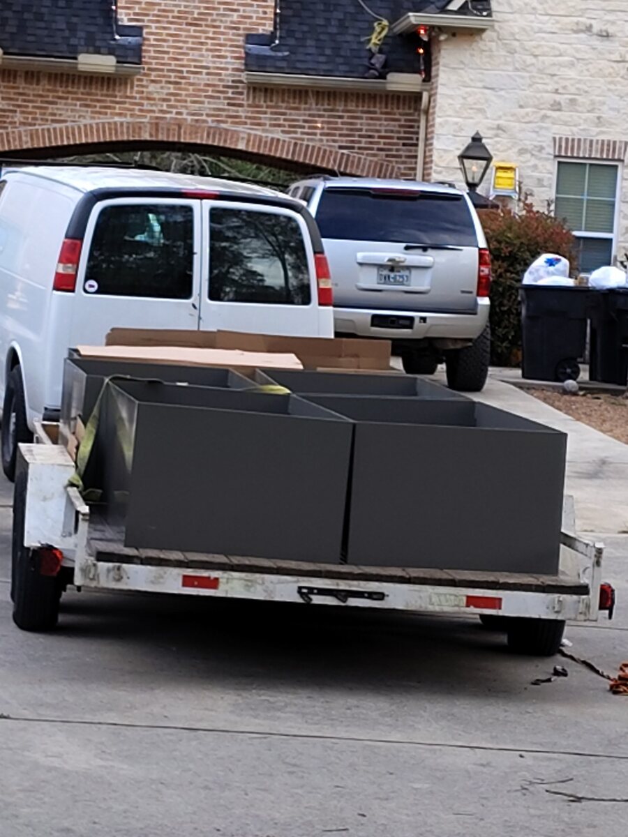 Custom steel planter boxes loaded on a trailer