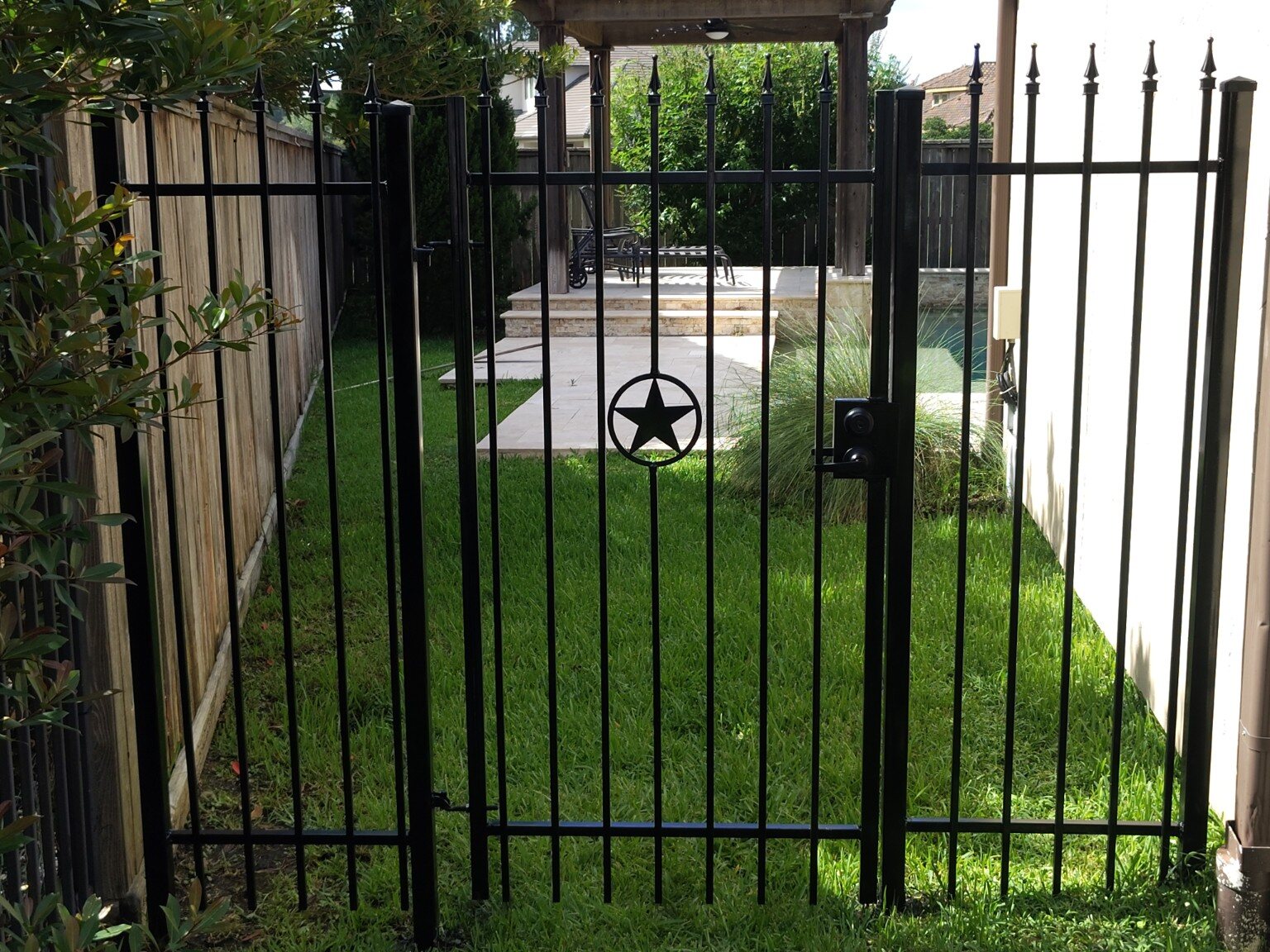 Custom black ornamental iron gate with Texas star